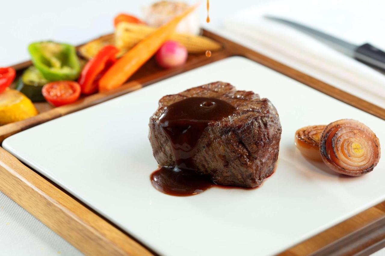 Symphony Style Hotel Kuwait Salmiya 외부 사진 A steak with sauce